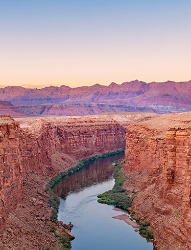 sunrise over a canyon river