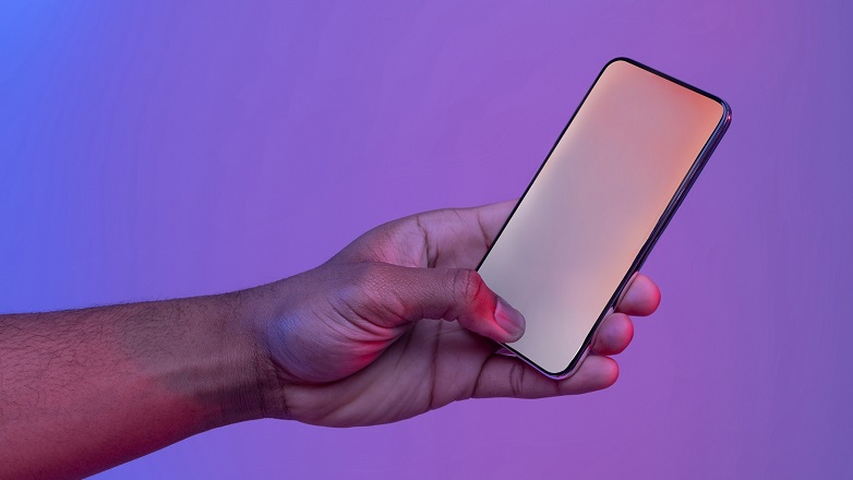 Mobile Phone in hand on purple background