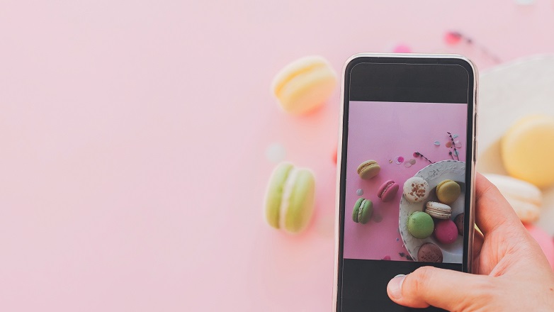 Phone taking photos of macaroons social media 782x400