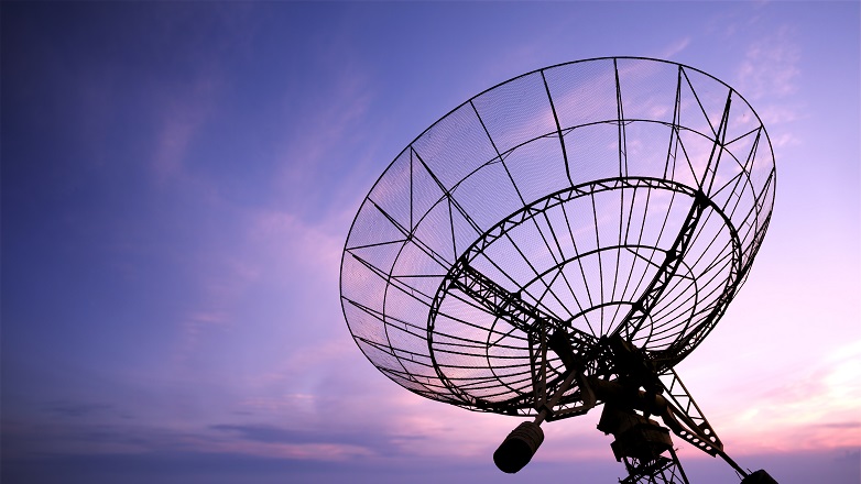Satellite dish against a pink sky
