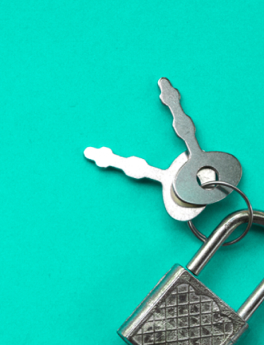 Padlock and keys on green background